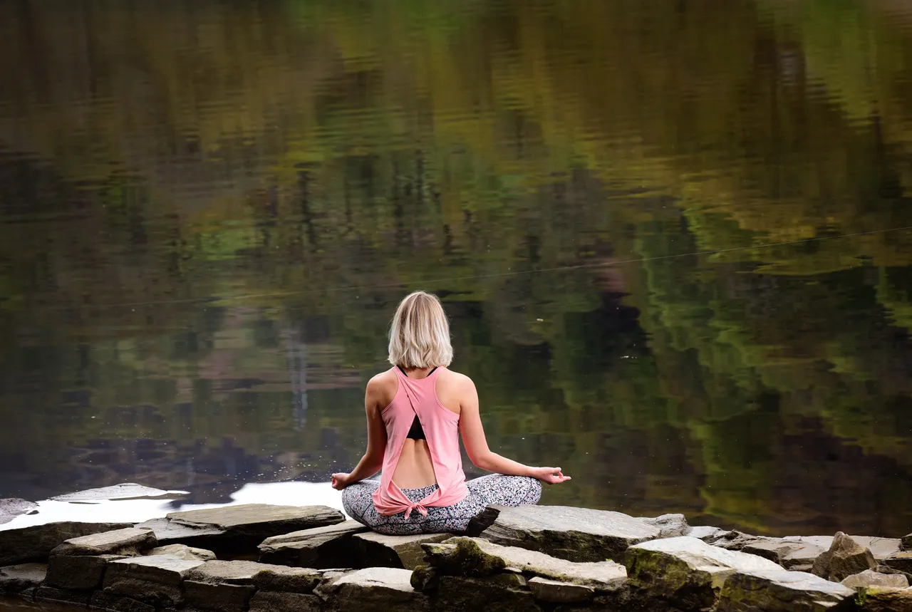 A woman practicing Yoga and Wellness at Loch Faskally